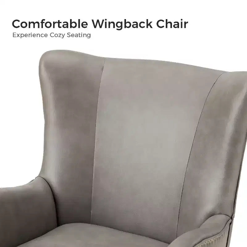 Fauteuil classique avec dossier à oreilles et clous décoratifs