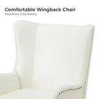 Fauteuil classique avec dossier à oreilles et clous décoratifs